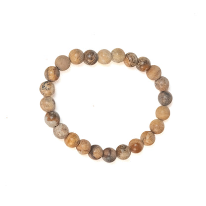 A beaded stretch bracelet made of round, polished brown and beige stone beads with natural speckles, displayed on a clean white background.