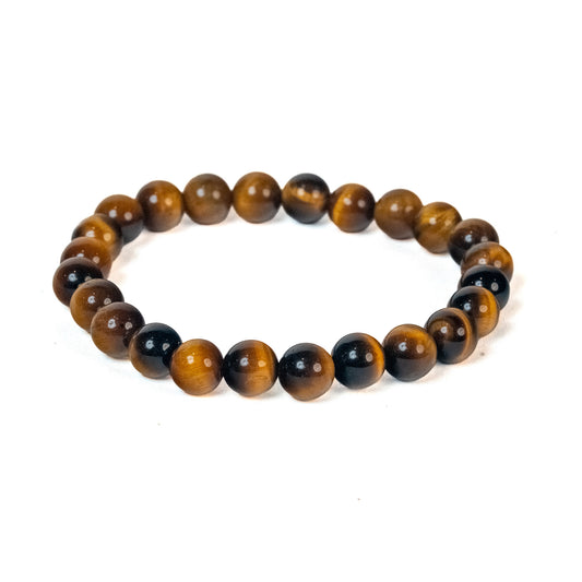 A beaded stretch bracelet made of polished tiger's eye and black stone beads, arranged in a circle on a plain white background.