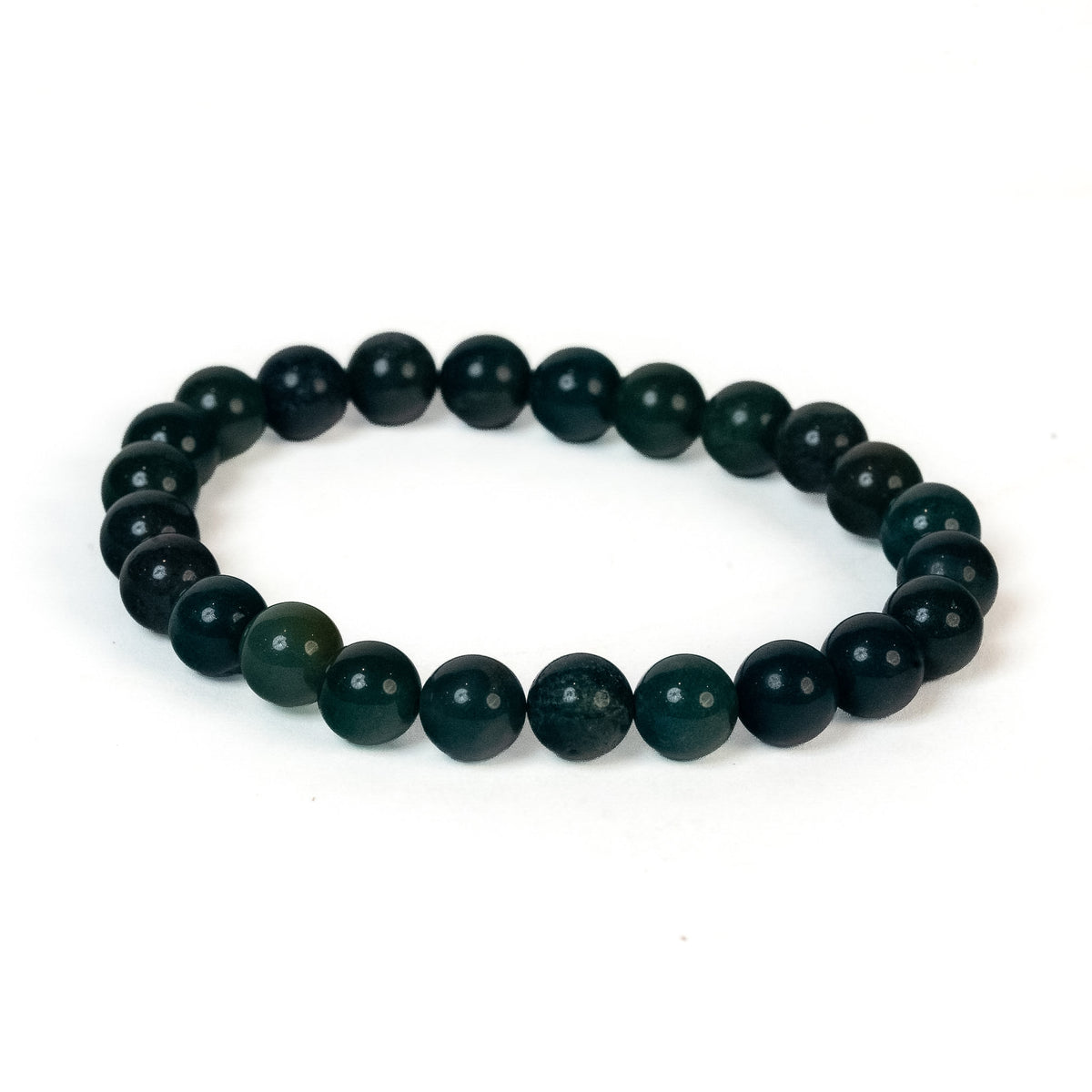 A beaded stretch bracelet made of dark green faceted round beads, displayed on a clean white background.